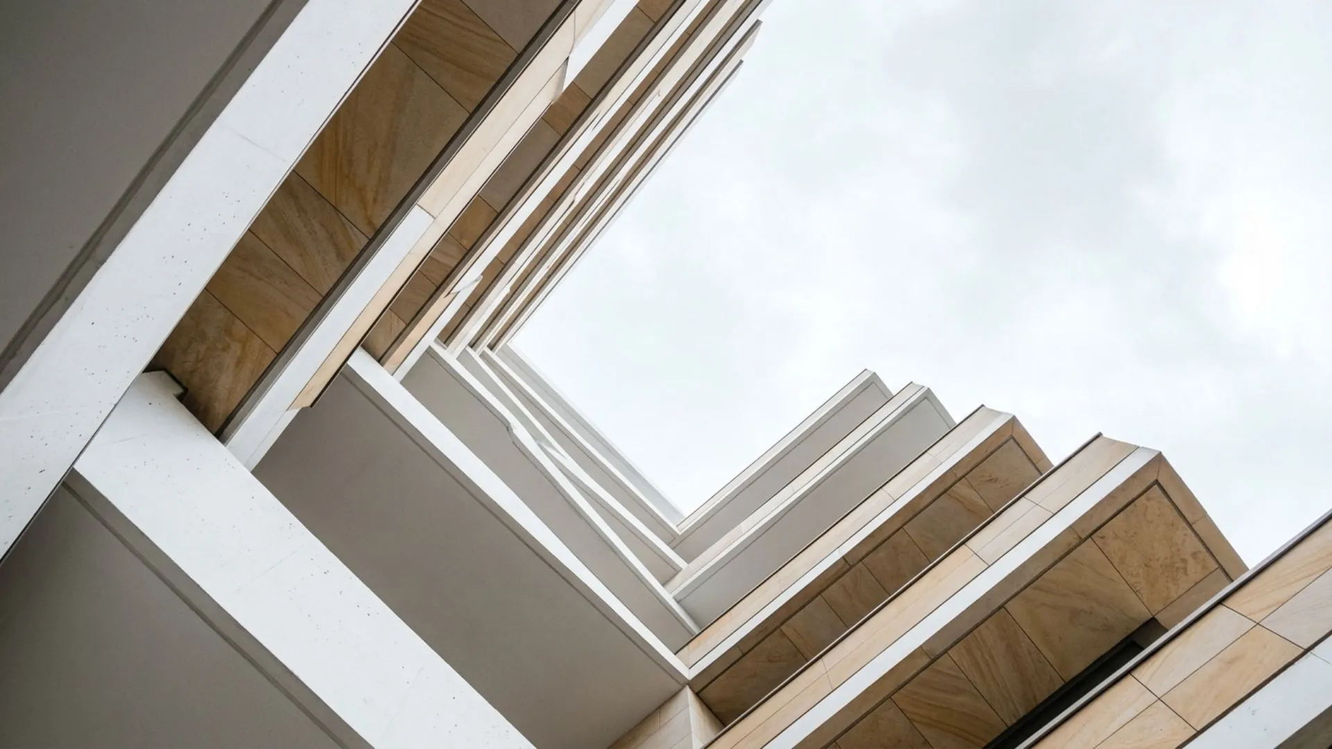 Looking up at the balconies of a modern apartment building