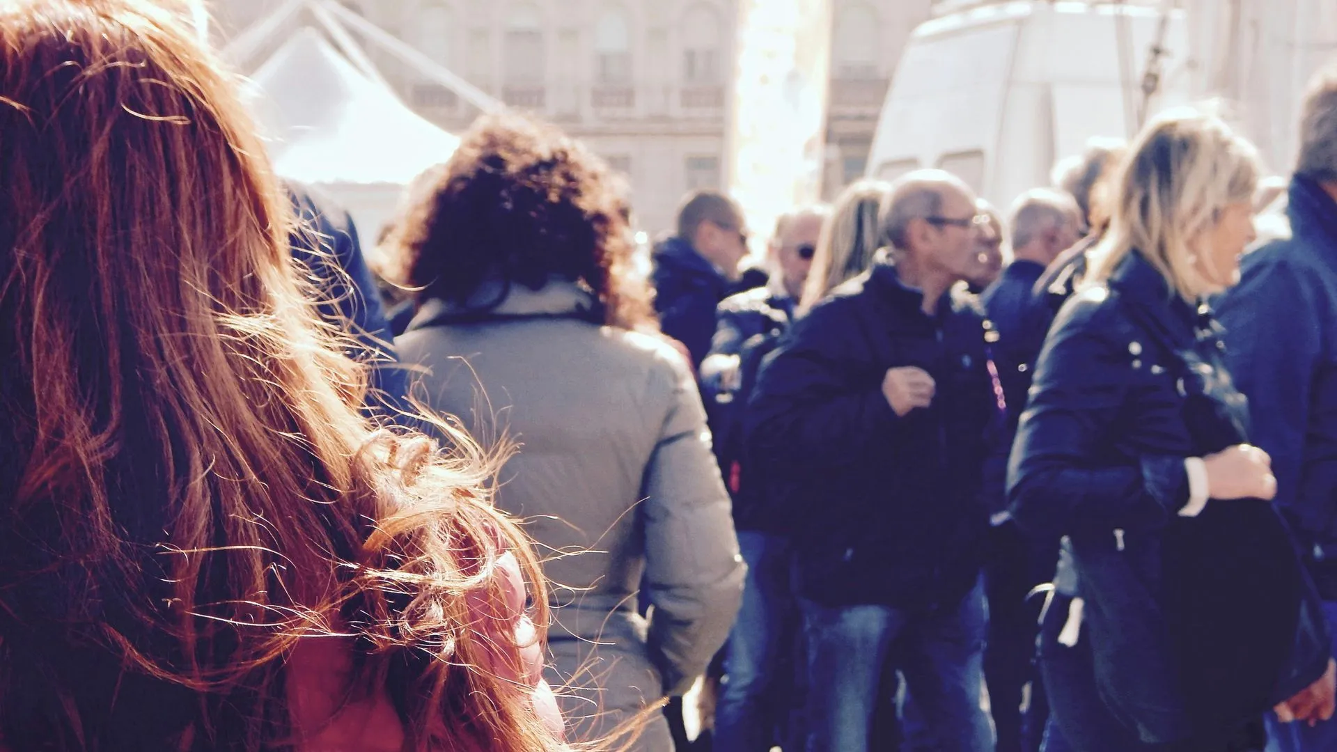Crowd of people moving through a busy public space