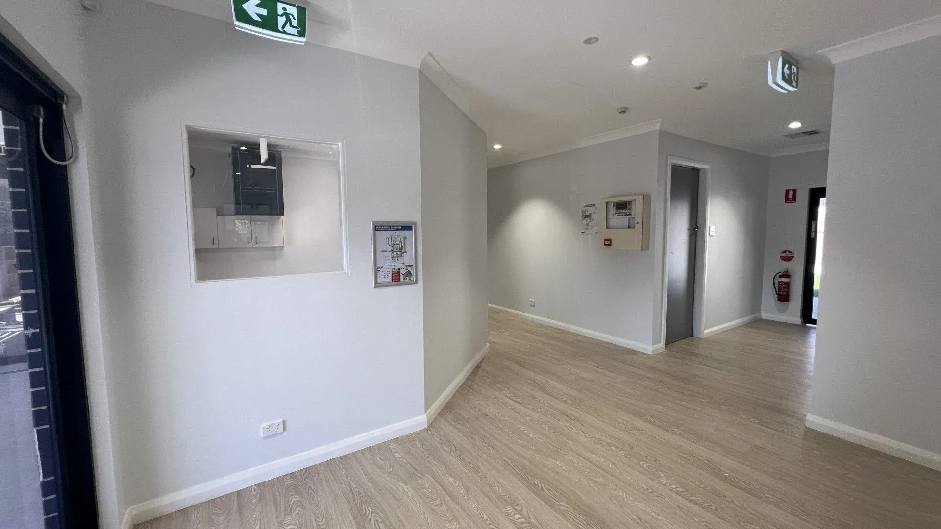 Childcare fitout hallway with exit signage and fire safety equipment
