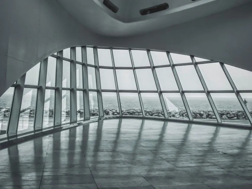 Commercial interior with curved floor to ceiling glazing and polished floor