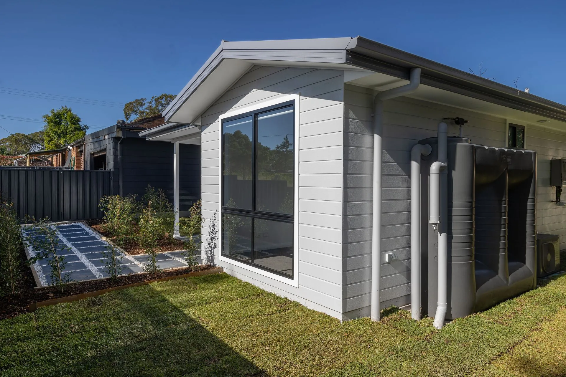 Side view of the weatherboard secondary dwelling at Halekulani with black framed windows