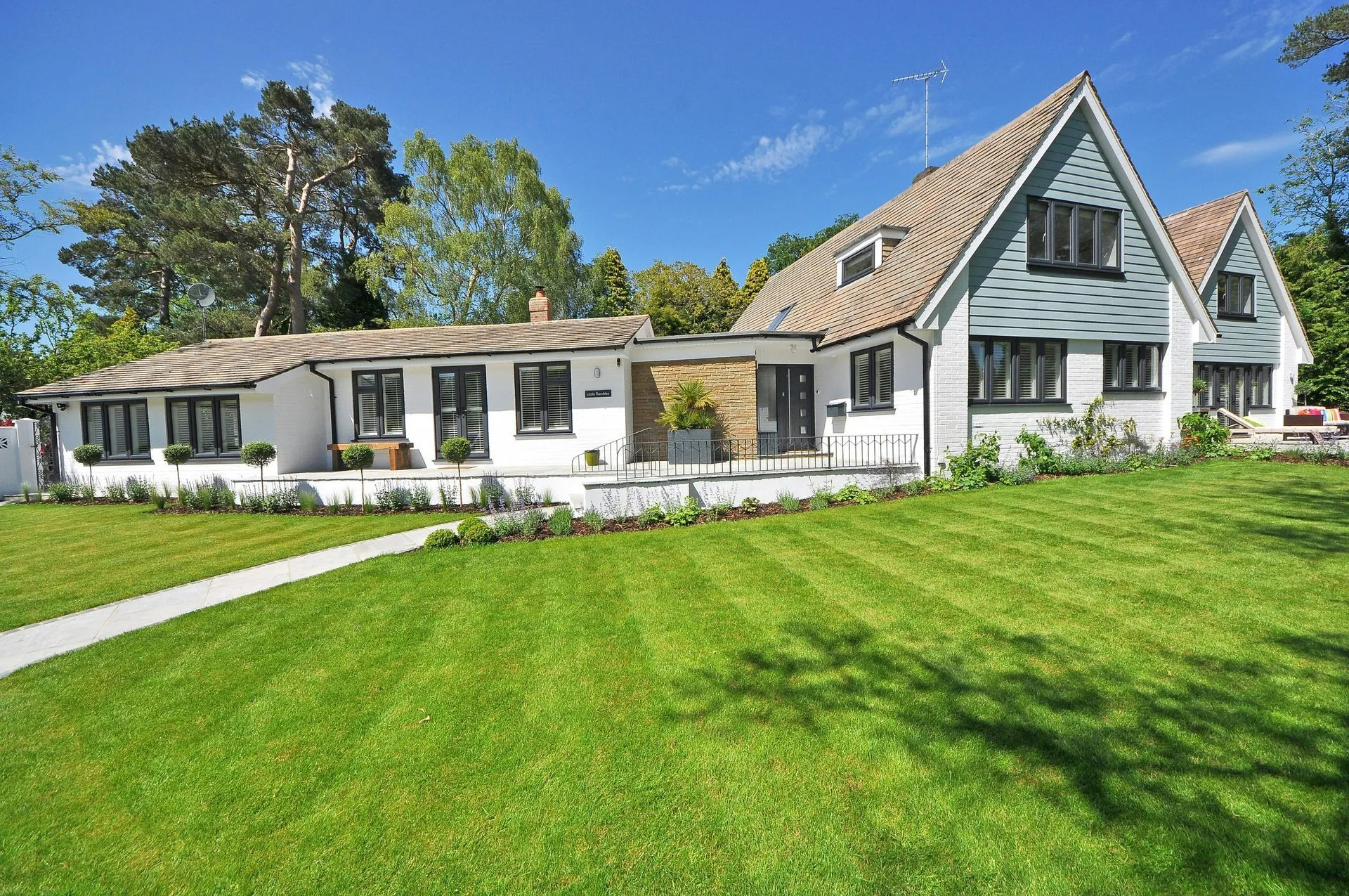 Home with a large landscaped lawn and established trees
