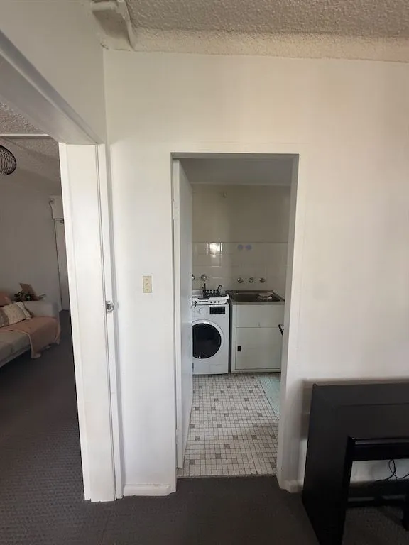 Hallway and laundry inside the Lilyfield strata apartment during structural assessment