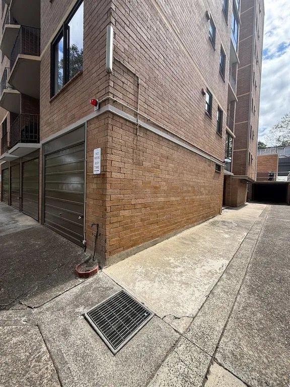 Brick exterior and driveway of the Lilyfield strata apartment building