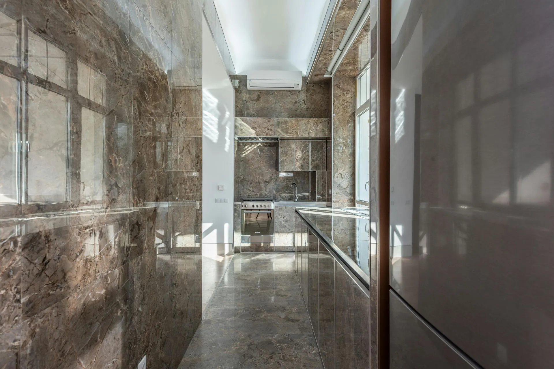 Marble clad commercial corridor with glazed partitions