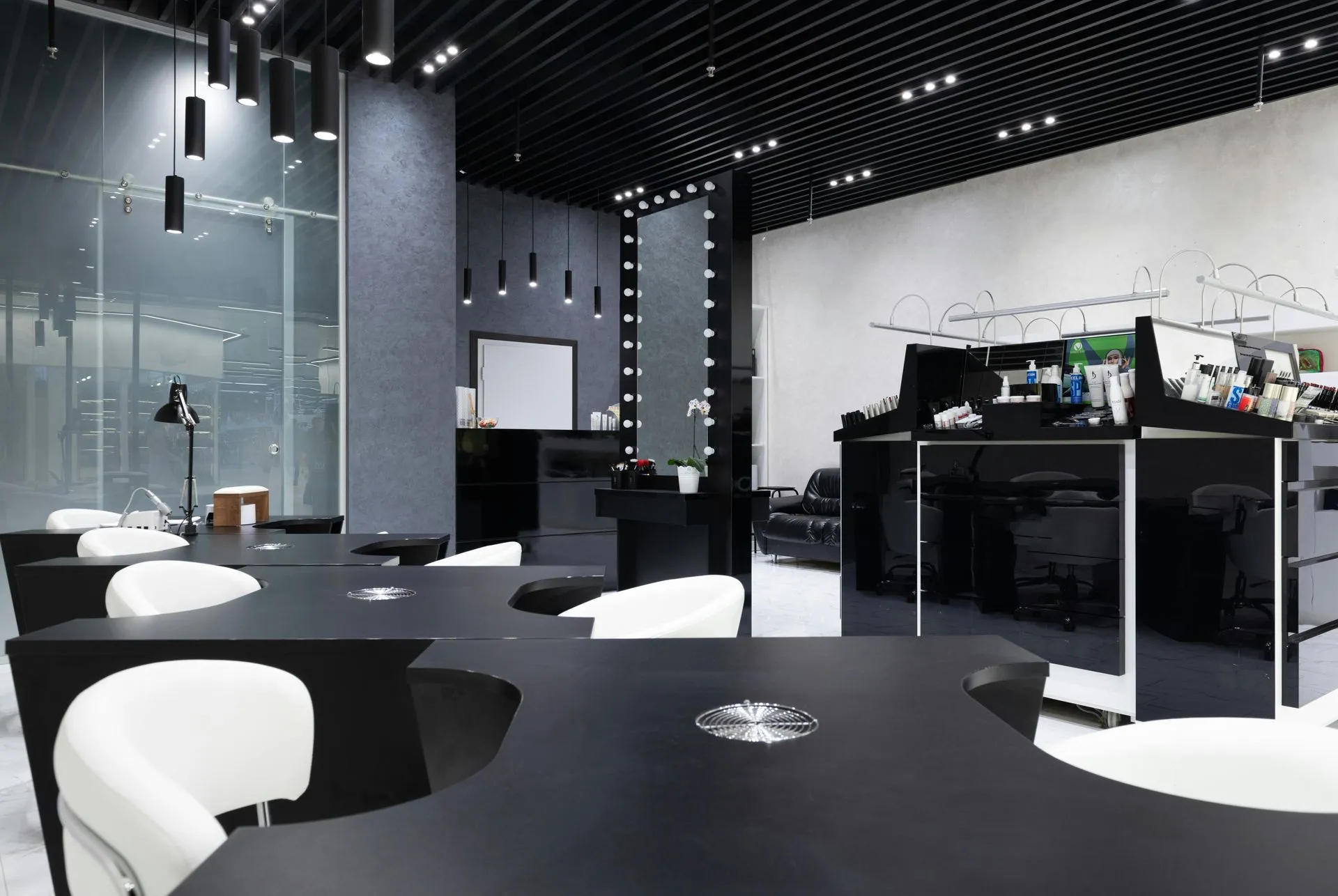 Modern office fitout with black joinery, white chairs and track lighting