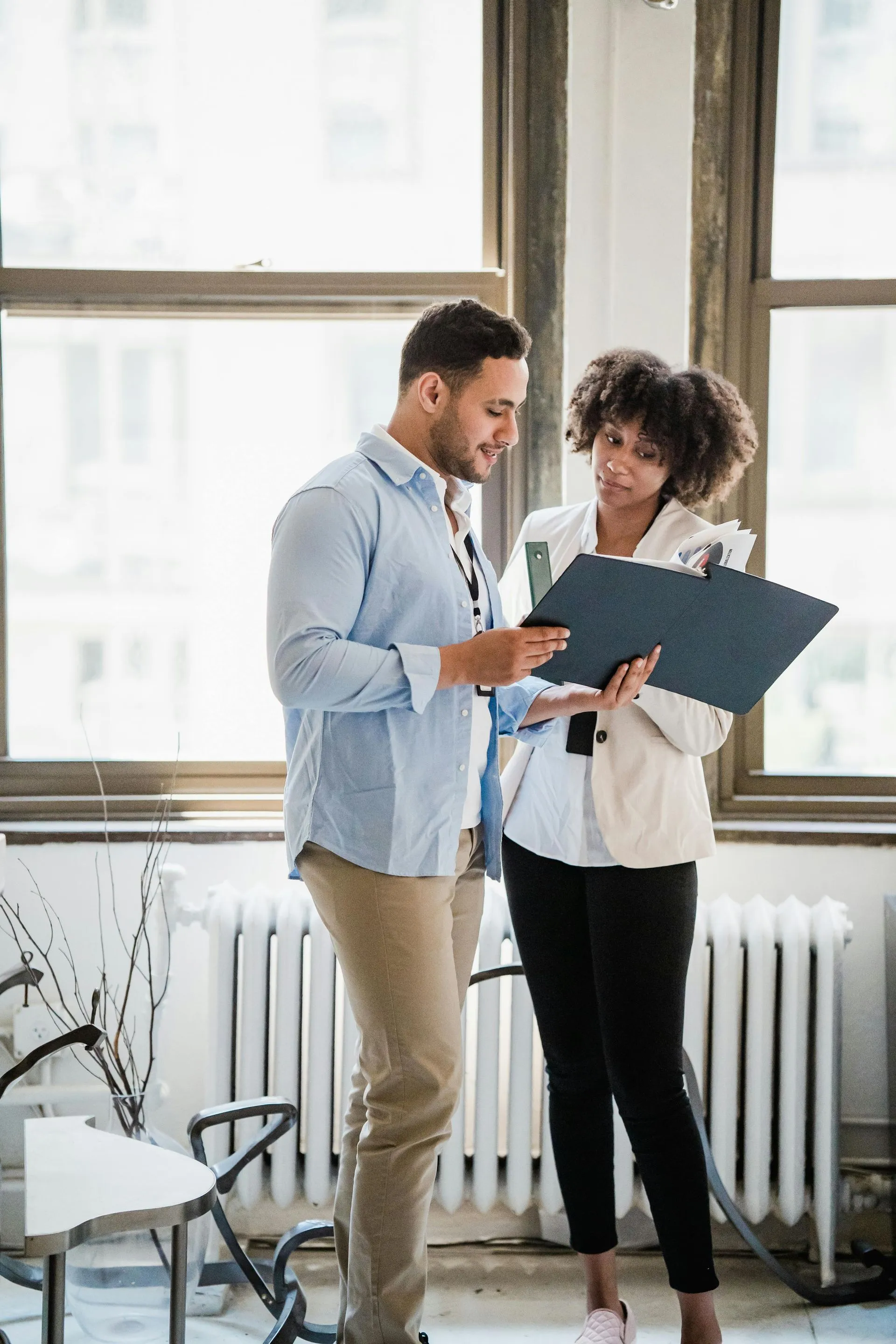Client and consultant reviewing documents during an office fitout consultation